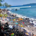 Pakaian bekas yang berhamburan di pantai Kawasari Kecamatan Aer Tembaga Kota Bitung, yang diangkut Kapal Penyelundup diduga dari Negara Malaysia, Selasa (17/1/2023). Foto: tangkapan layar dari akun Facebook Sulawesi Utara Community.